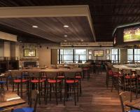 a dining room with tables and chairs and a tv at Crowne Plaza Chicago O'Hare Hotel & Conference Center by IHG in Rosemont