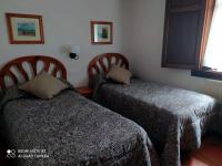 Postel nebo postele na pokoji v ubytování La Casona de Mestas