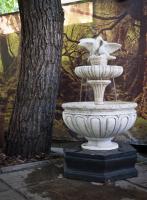 a white fountain with two birds on top of it at Hotel Barbaris in Kyiv