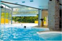 a person swimming in a swimming pool in a house at T2 RESIDENCE 3 ETOILES Piscine chauffée Sauna Hammam in Cauterets