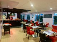 a dining room with tables and chairs in a restaurant at KYRIAD Issoudun in Issoudun
