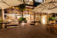 a lobby of a building with tables and umbrellas at Crowne Plaza Vientiane by IHG in Vientiane