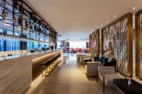 a restaurant with a bar with couches and chairs at Crowne Plaza Vientiane by IHG in Vientiane