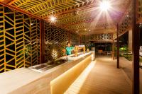 a woman standing at a bar in a restaurant at Crowne Plaza Vientiane by IHG in Vientiane