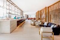 a restaurant with a bar with chairs and tables at Crowne Plaza Vientiane by IHG in Vientiane