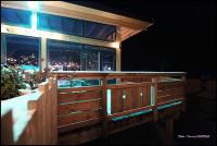 a wooden fence in front of a restaurant at night at Domaine du Hirtz, Restaurant &amp; Spa in Wattwiller