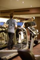 a person standing on a treadmill in a gym at Holiday Inn Vienna City by IHG in Vienna