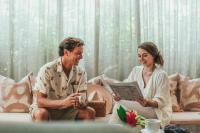 a man and a woman sitting on a couch at Hotel Renew in Honolulu