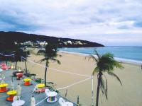 a sandy beach with palm trees and the ocean at 湛藍海岸民宿 Azure--這個夏天有點藍--墾丁南灣沙灘-可包棟-國旅卡特約店 in Nanwan