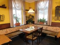 a dining room with a table and chairs and windows at Mecklenburger Hof in Mirow