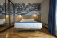 A bed or beds in a room at Aparthotel Campus