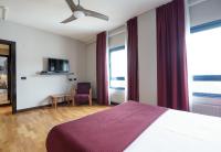 A bed or beds in a room at Aparthotel Campus