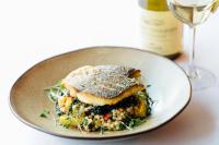 a plate of food with a piece of fish on top at The Maltsters Arms in Totnes