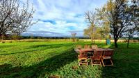 a wooden table and chairs in the middle of a field at La Motte in Louroux-de-Bouble
