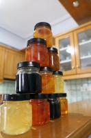 a pile of jars of pickles on a kitchen counter at Nafpaktos Apartments in Nafpaktos