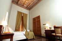 A bed or beds in a room at Le Stanze Del Vicerè Boutique Hotel