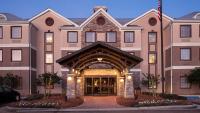 a large building with an archway in front of it at Staybridge Suites Jackson by IHG in Ridgeland