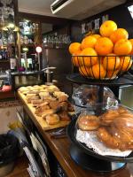 Une boulangerie avec un bouquet de beignets et d'oranges sur un comptoir dans l'établissement Hotel Bella Dolores, à Lloret de Mar