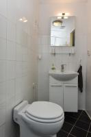 a white bathroom with a toilet and a sink at De Witte Molen Kranenburg in Kranenburg