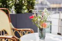 a vase filled with flowers sitting on a table at Maison Albar - Le Vendome in Paris