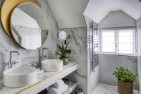 a bathroom with two sinks and a mirror at Maison Albar - Le Vendome in Paris