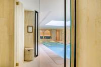 a swimming pool is seen through a glass door at Maison Albar - Le Vendome in Paris