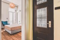 A bed or beds in a room at Neoclassical Apartment near Acropolis - LivingStone Crystal