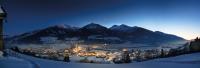 a view of a town in the mountains at night at Alpine View Apartments in Niedernsill