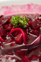 a bowl of red beets with a green plant on top at Premier Resort Cutty Sark in Scottburgh