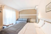 Łóżko lub łóżka w pokoju w obiekcie Hotel Rubino