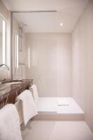 a bathroom with white towels and a sink at Hôtel Alfred Sommier in Paris