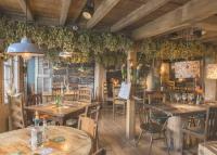 a dining room with wooden tables and chairs at The Five Bells Inn in Brabourne