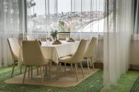 a dining room with a white table and chairs at RAYA Garden - Park Hotel & Winery in Veliko Tŭrnovo