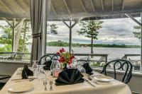 a dining table with a view of the water at Bonnie Castle Resort & Marina in Alexandria Bay
