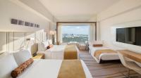 a hotel room with two beds and a flat screen tv at The Prince Gallery Tokyo Kioicho, a Luxury Collection Hotel in Tokyo