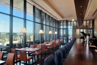 a restaurant with tables and chairs and large windows at The Gate Hotel Kaminarimon by Hulic in Tokyo