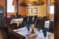 a dining room with tables and chairs in a restaurant at The Parlour Inn, an Ascend Collection Hotel in Stratford
