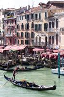 a group of people in gondolas in the water near buildings at Hotel Marconi in Venice