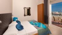 A bed or beds in a room at G House Rimini Spiaggia