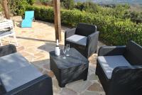 a patio with chairs and a table with wine glasses at Luciana in La Croix-Valmer
