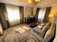 a living room with a couch and a table at Hotel Arnia in Iaşi