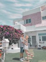 a man and a woman standing in front of a house at Minami Kaze in Magong