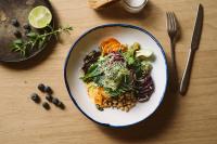 talerz żywności z fasolą i warzywami na stole w obiekcie The HEY HOTEL w mieście Interlaken