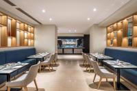 a dining room with long tables and chairs at Mitsis Rodos Village in Kiotari