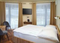 Postel nebo postele na pokoji v ubytování Hotel Dymník