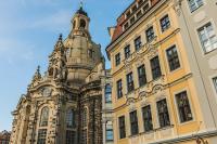 an old building with two towers on a street at Hotel Suitess in Dresden