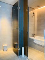 a bathroom with a shower and a toilet and a sink at City Suites - Kaohsiung Chenai in Kaohsiung