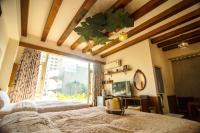 a bedroom with two beds and a large window at Seville Countrified B&amp;B in Hualien City