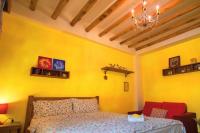 a bedroom with a bed and a yellow wall at Seville Countrified B&amp;B in Hualien City