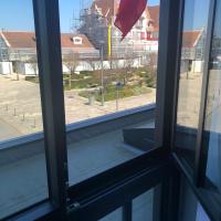 an open window with a view of a street at Amirauté in La Baule